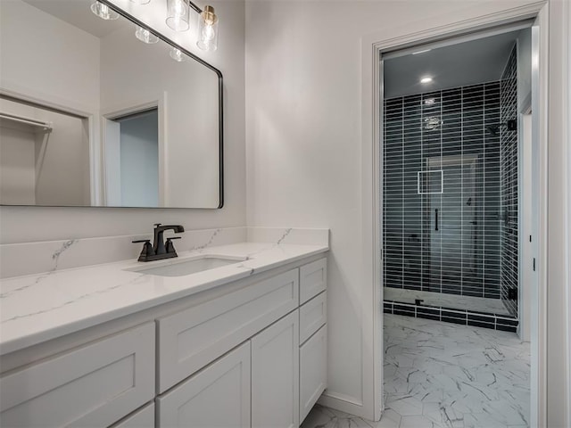 bathroom featuring vanity and tiled shower