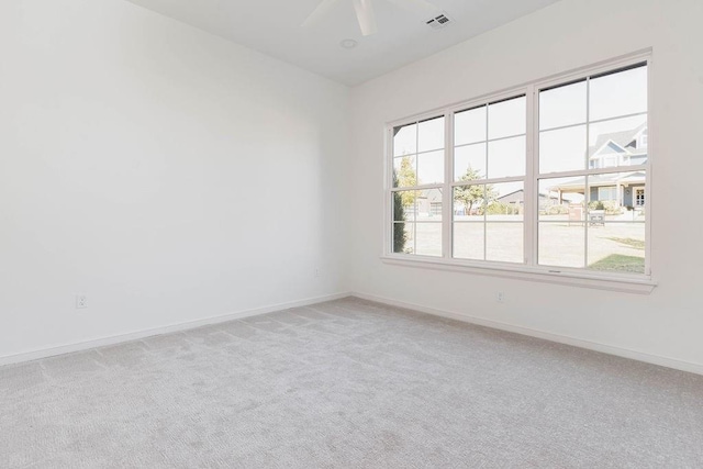 empty room featuring light colored carpet and ceiling fan