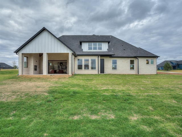 back of property featuring a yard and a patio area