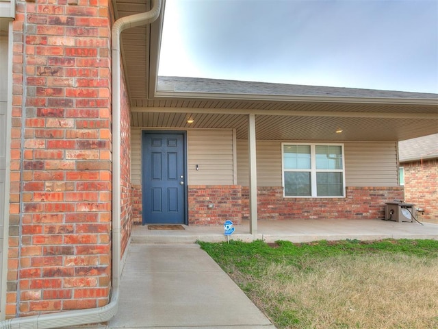 view of exterior entry with covered porch