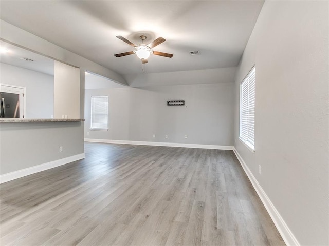 spare room with light wood-type flooring and ceiling fan