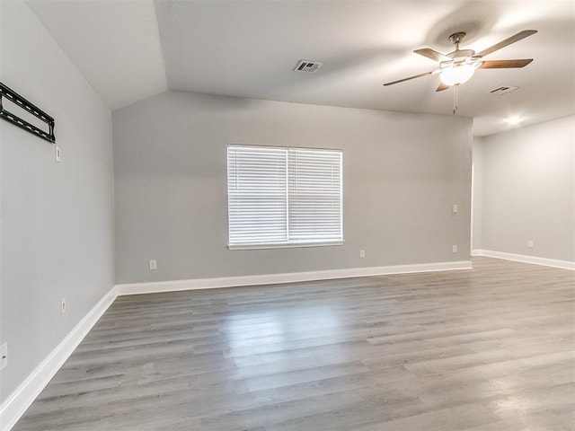 unfurnished room featuring ceiling fan, lofted ceiling, and light wood-type flooring