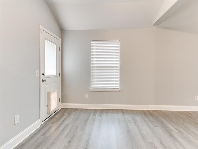 entryway featuring light hardwood / wood-style flooring and lofted ceiling