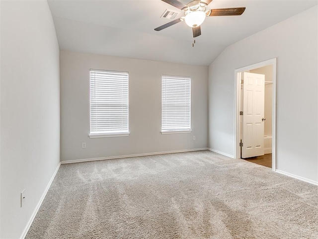 carpeted empty room featuring ceiling fan and lofted ceiling