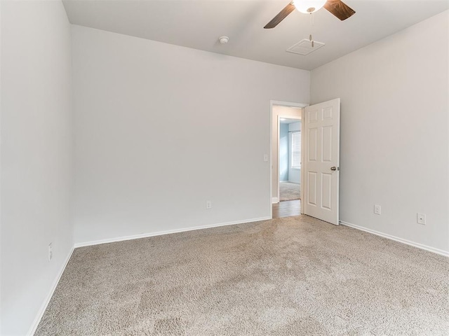 carpeted spare room featuring ceiling fan