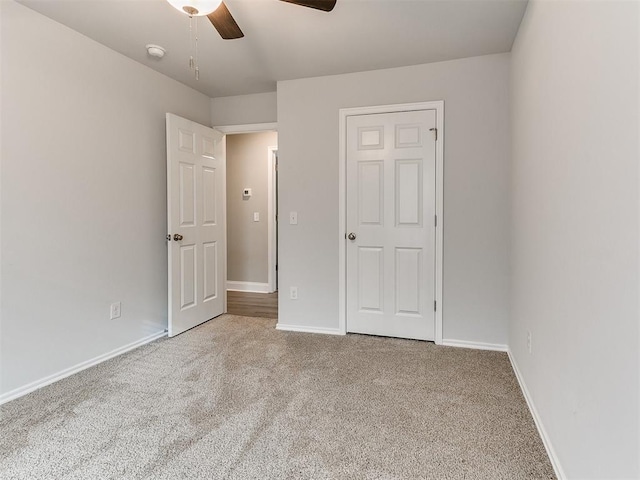 unfurnished bedroom featuring carpet and ceiling fan