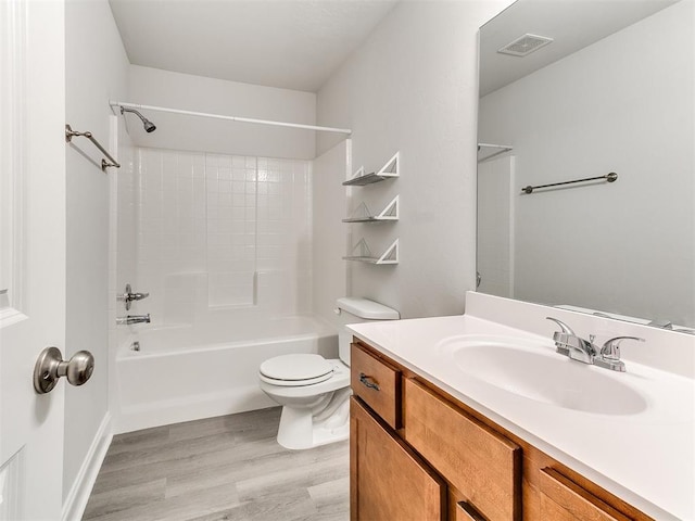 full bathroom with bathing tub / shower combination, toilet, vanity, and hardwood / wood-style flooring