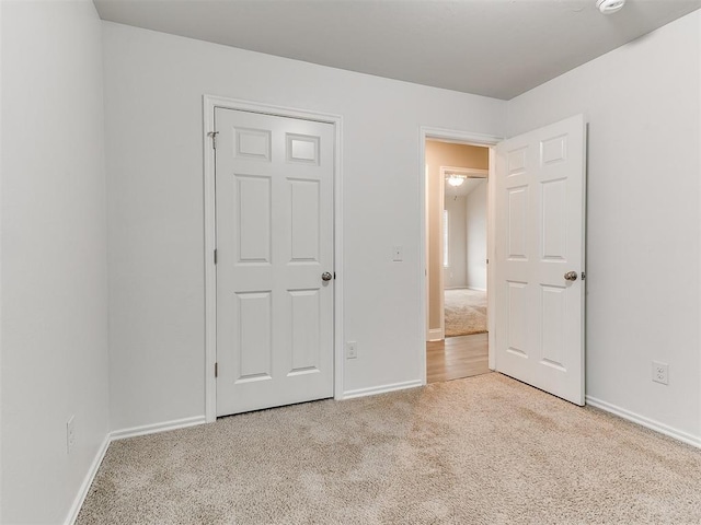 unfurnished bedroom featuring light colored carpet