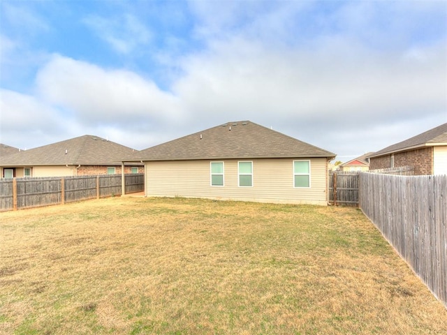 rear view of property featuring a yard