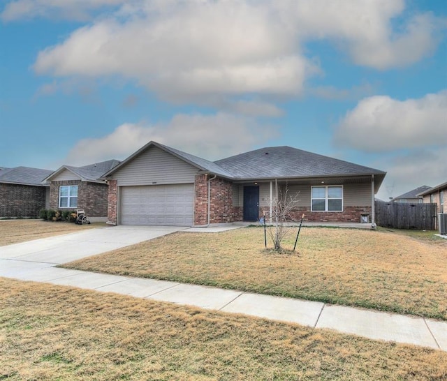 ranch-style home featuring central air condition unit, a front lawn, and a garage