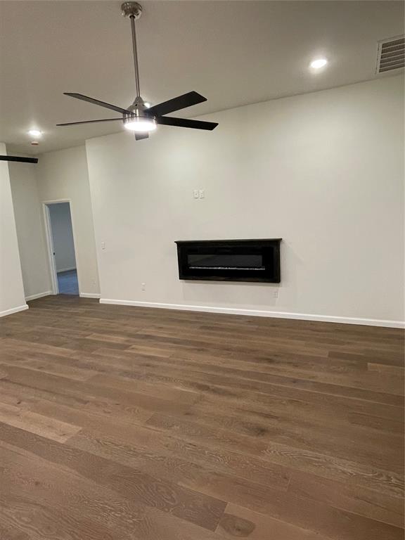 interior space with ceiling fan and dark wood-type flooring