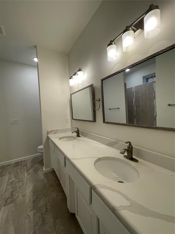 bathroom featuring vanity and toilet