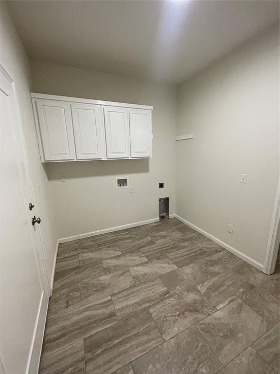 clothes washing area with washer hookup, electric dryer hookup, and cabinets