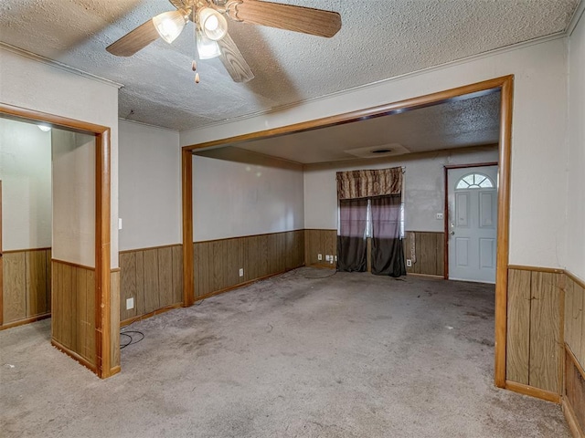 carpeted spare room with ceiling fan and a textured ceiling