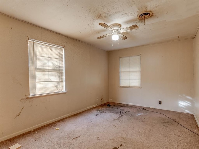 empty room with ceiling fan and carpet floors