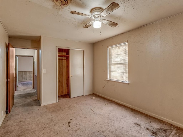 unfurnished bedroom with ceiling fan and light colored carpet