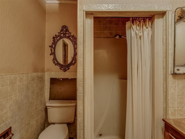 bathroom with vanity, tile walls, and toilet