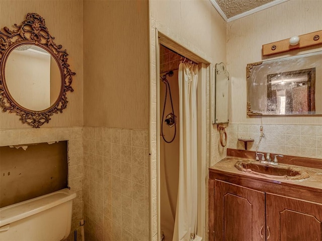 bathroom with vanity, toilet, and tile walls