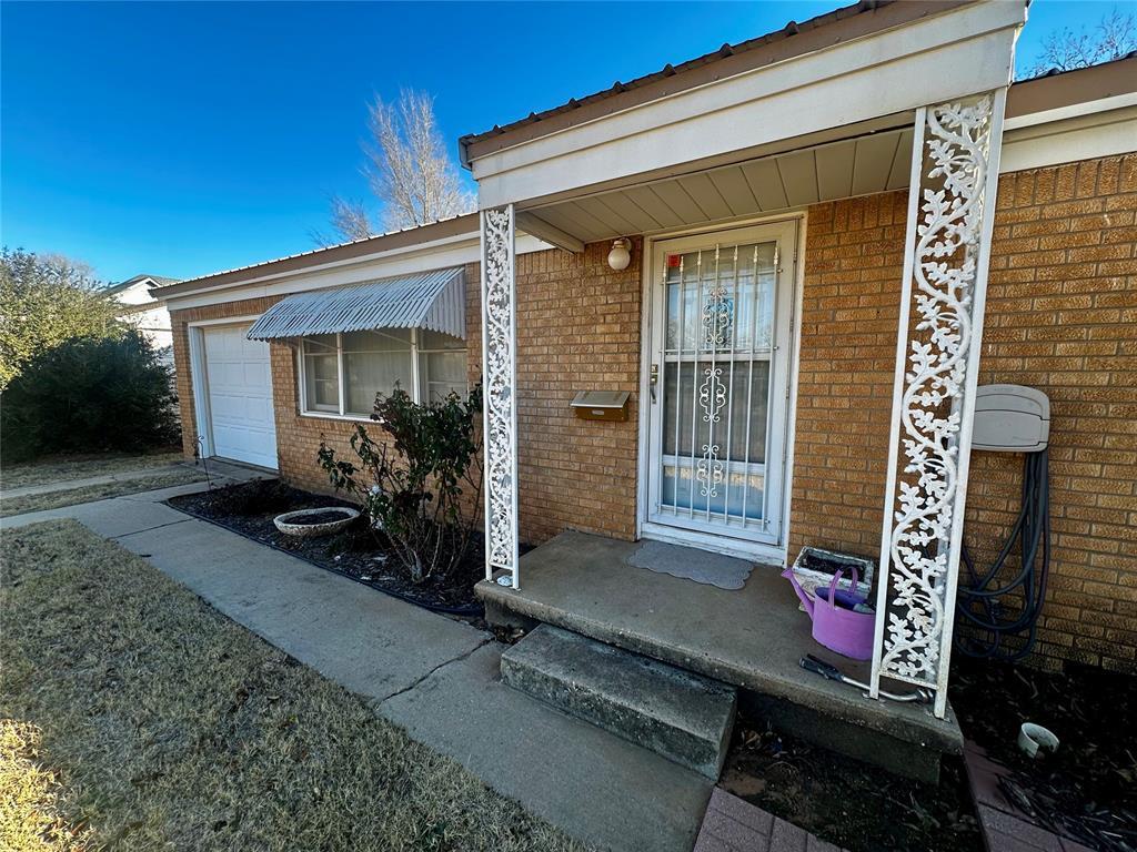 view of exterior entry with a garage