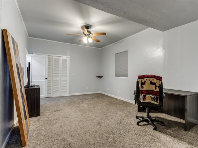 carpeted home office featuring ceiling fan and ornamental molding