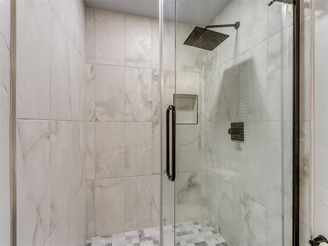 bathroom featuring a shower with door