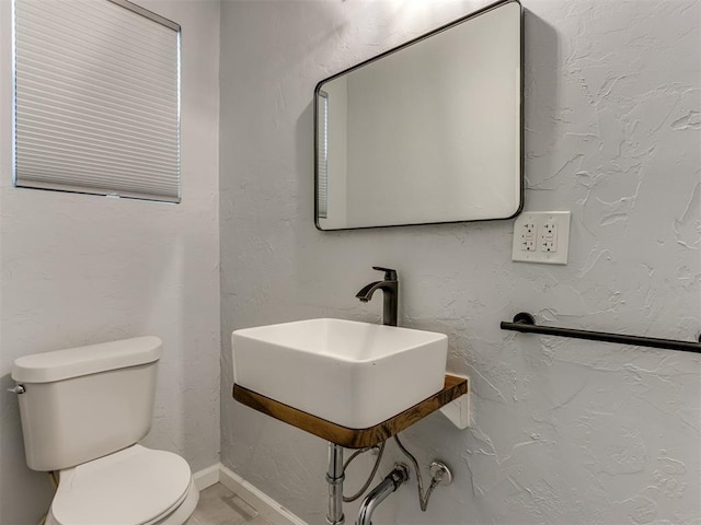 bathroom featuring sink and toilet