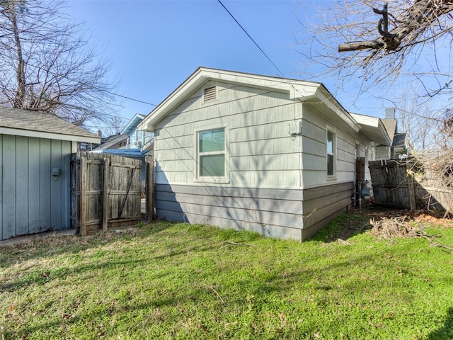 view of side of property with a yard