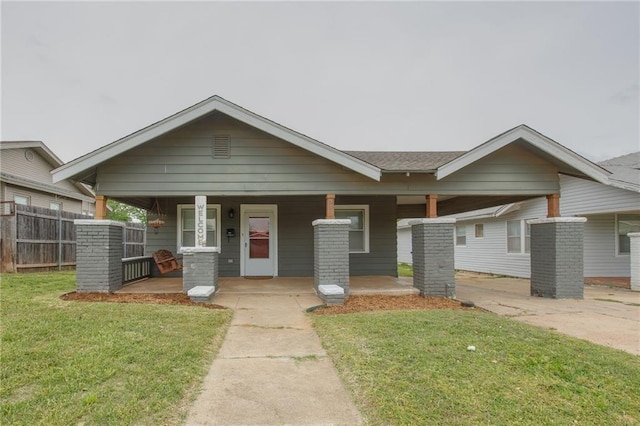 view of front facade with covered porch and a front lawn