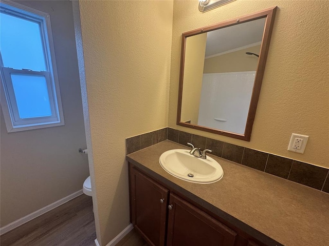 bathroom with hardwood / wood-style floors, vanity, and toilet