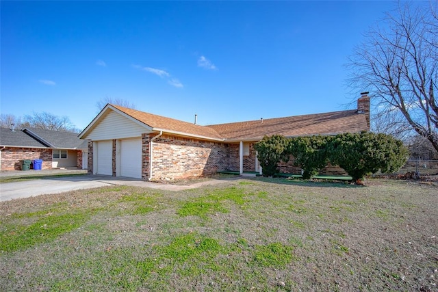 ranch-style home with a garage and a front lawn