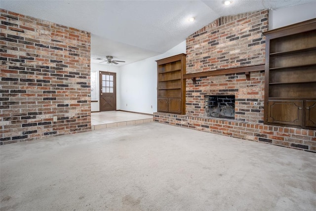 unfurnished living room with ceiling fan, light colored carpet, a textured ceiling, vaulted ceiling, and a fireplace