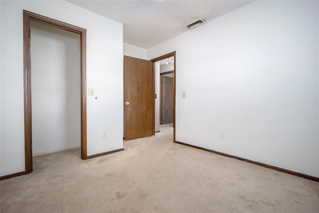 unfurnished bedroom featuring light carpet