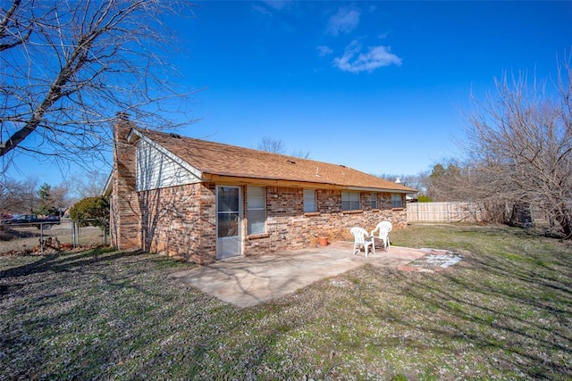 rear view of house with a patio area and a yard