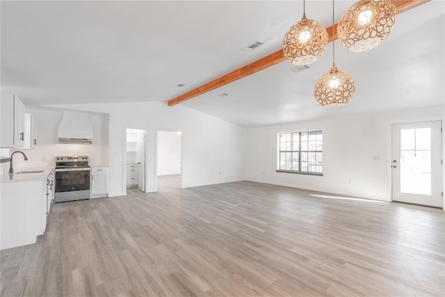 unfurnished living room with vaulted ceiling with beams, light hardwood / wood-style flooring, and sink