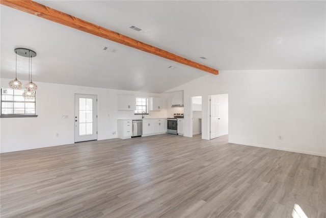 unfurnished living room with vaulted ceiling with beams, light hardwood / wood-style floors, and a wealth of natural light