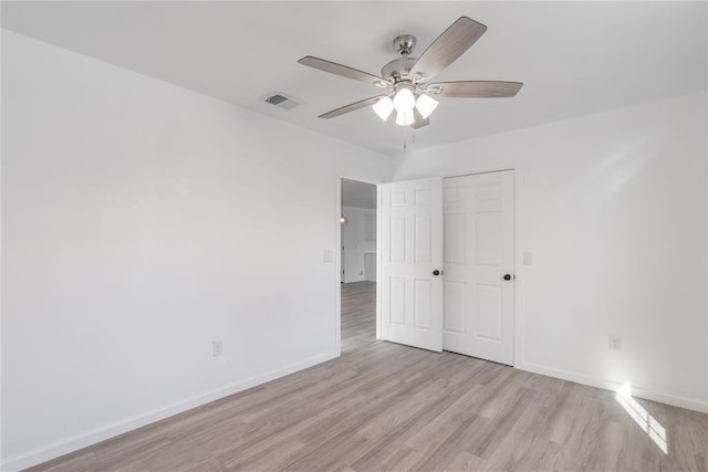 unfurnished bedroom featuring a closet, light hardwood / wood-style floors, and ceiling fan