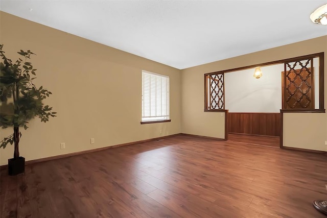 empty room with hardwood / wood-style floors