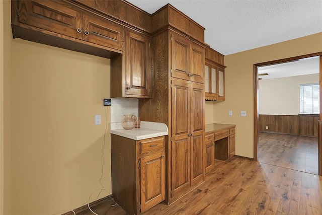 kitchen featuring wood-type flooring and a textured ceiling