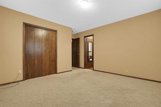 unfurnished bedroom with a closet and light carpet