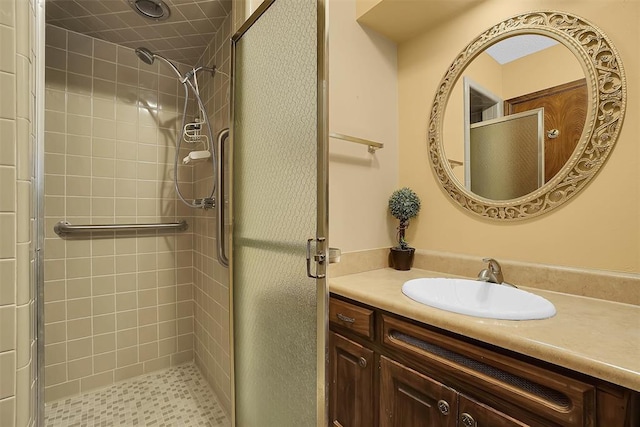 bathroom with vanity and a tile shower