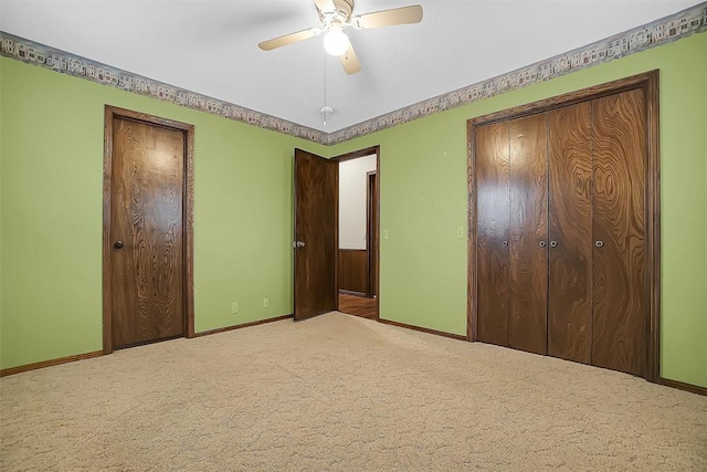 unfurnished bedroom featuring ceiling fan and carpet flooring