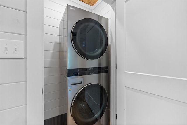 clothes washing area with stacked washer / drying machine