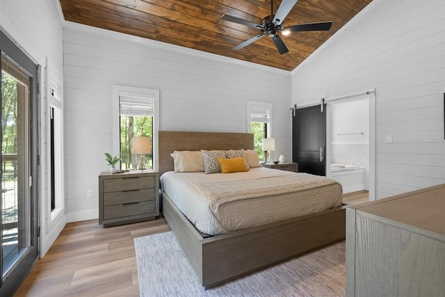 bedroom with vaulted ceiling, ceiling fan, a barn door, wooden ceiling, and light hardwood / wood-style floors