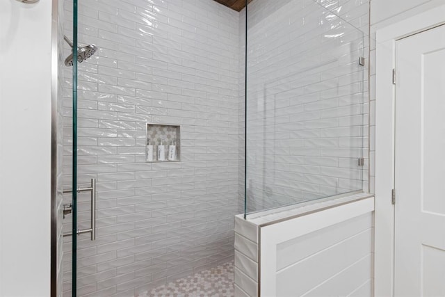 bathroom with tiled shower