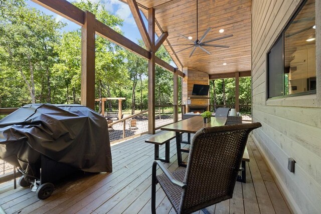 deck with ceiling fan, a fireplace, and grilling area