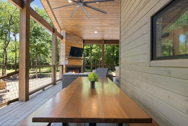 exterior space featuring wooden walls, lofted ceiling, wooden ceiling, and exterior fireplace