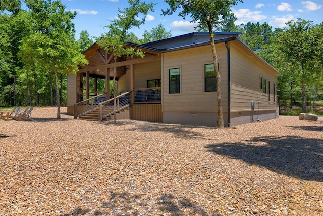 exterior space with ceiling fan and a porch