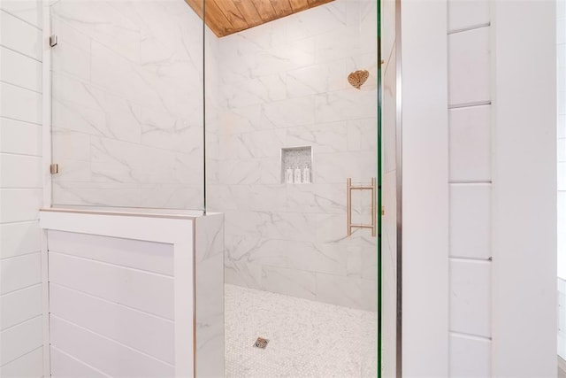 bathroom with wood ceiling and a walk in shower