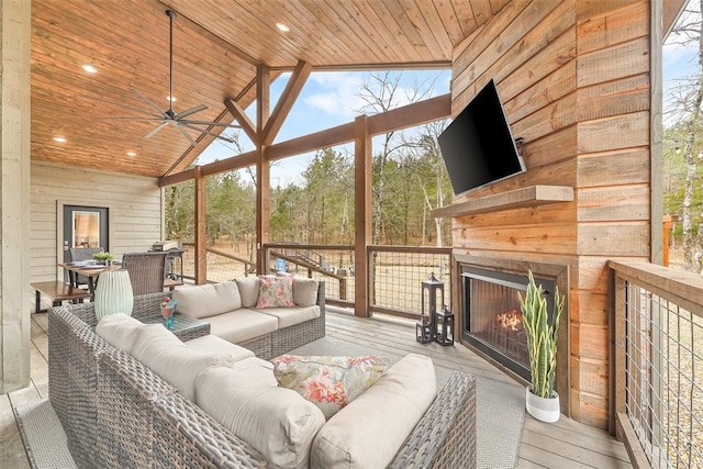 living area with a healthy amount of sunlight, high vaulted ceiling, and wood ceiling