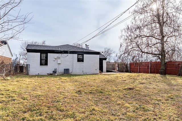 rear view of house featuring a lawn